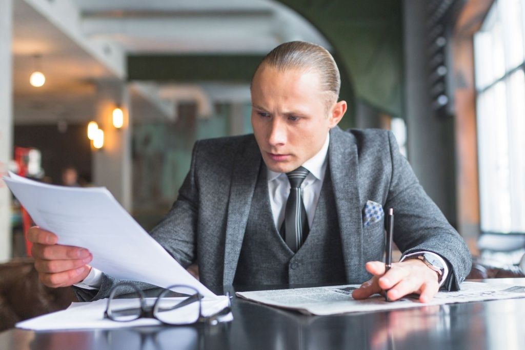 businessman-examining-document-caf.jpg